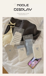 Flat lay of blue and white heart socks with bow details and striped patterns