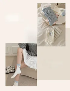 Detailed knit socks with heart bows and blue ruffles in soft cotton material