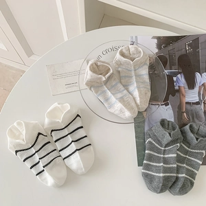 Three pairs of breathable striped mesh socks in cotton displayed on a white table
