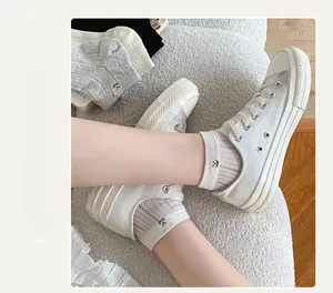 Close-up of cute bear embroidery and ribbed texture on cotton mesh ankle socks