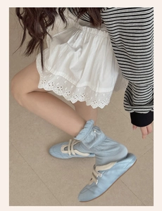 Detailed view of light blue Mary Jane shoes with ruffled bow socks and pearl accents