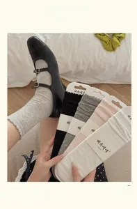 Detail of ruffle cuff socks with embossed texture in various colors and Mary Jane shoes