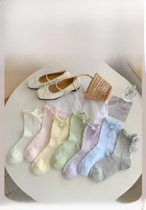 Colorful mid-calf socks with bow details and ribbed texture in macaron pastel shades