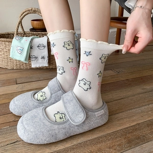 Cute puppy cartoon socks with lace trim and gray felt slippers on wooden floor