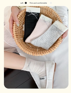 Detail of mesh socks with silver leather bows in black, pink, grey and cream white