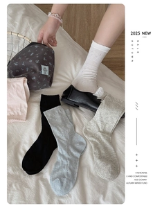 Close-up of heart-pattern knit socks with scalloped edges in multiple soft colors