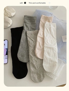 Detail of five pairs of cotton crew socks featuring bow patterns and ruffled cuffs