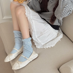 Blue bow ruffle socks paired with white satin Mary Jane shoes in a soft Korean style