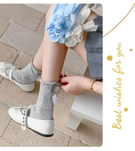 Detail showing knit pattern and ribbon bow on pastel crew socks for women