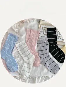 Detail view of five pairs of cotton socks with lace trim and elegant grid patterns