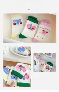 Detail of cute cartoon elephant socks with colorful strawberry patterns and ribbed cuffs