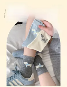 Detail of cute Westie puppy jacquard crew socks with delicate blue ribbon bow decoration
