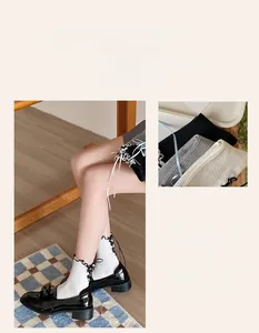 Detail of sweet Lolita mesh socks with lace trim and ribbon bow tie in basic colors