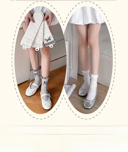 Detail of sweet mid-calf socks with lace trim, stripes, and bows in white and grey colors