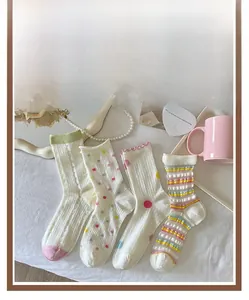 Detail display of colorful polka dot and striped cotton socks with ruffled edges