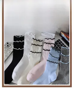 Detail of colorful cotton crew socks featuring ruffled edges and ribbed knit texture