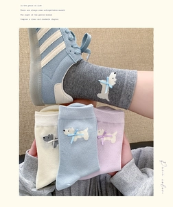 Detail of cute Westie puppy pattern and 3D bow on cotton crew socks in pastel colors
