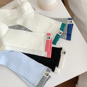Set of multi-color ribbed crew socks for women featuring cute cartoon fabric labels