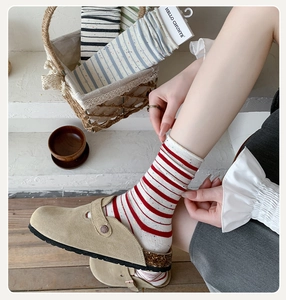 Detail of red striped cotton socks with colorful flecks and a trendy rolled edge