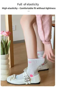 Elastic white mesh socks with pink polka dots and ruffled cuffs shown in close-up detail