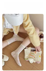 Detail of white cotton mesh socks with colorful polka dots in a cozy lifestyle setting