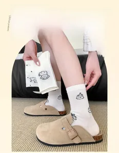 Detailed view of white cotton socks with cartoon dog pattern and ribbed cuffs