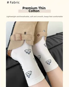 Detail of Westie dog pattern on breathable thin cotton mid-calf socks for women
