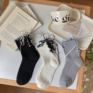 Three-pack Lolita crew socks with lace trim and ribbon bows in black, white, and grey