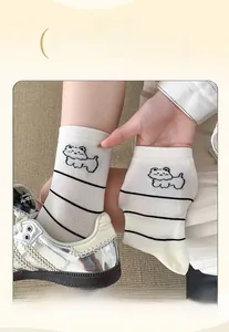 Detail of high-elasticity wide cuff on white mid-calf socks with cartoon dog design