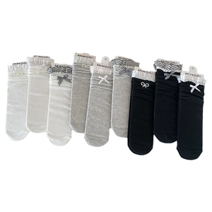 Three-pack of girls' lace ruffle socks with bows in black, white, and grey colors