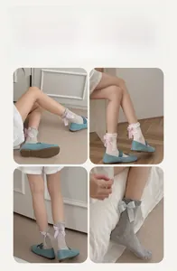 Detail of mesh socks with large decorative bow on heel and elegant ruffled cuffs