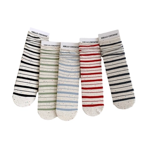 Five pairs of colorful striped crew socks with nep yarn texture on white background