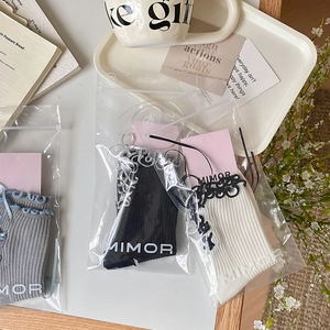 Lolita style bow socks with ribbon straps and wavy edges in grey, black, and white colors