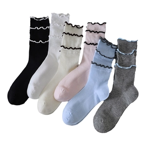 Six pairs of women's ruffled cotton crew socks in pastel colors with wavy lace trim