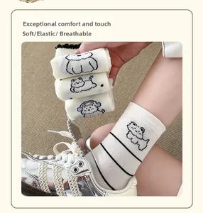 Close-up of white crew socks with cartoon dog patterns and black stripes details