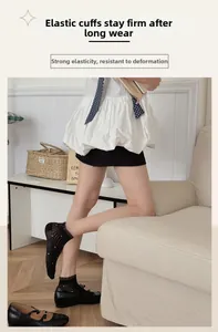 Close-up of elastic cuff on black mesh ankle socks with white polka dots for women