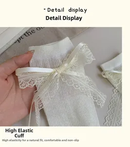 Detail showing the elastic cuff of a white ballet-style lace bow mid-calf sock