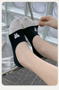 Detail of invisible cotton socks featuring bow embroidery and black and white contrast