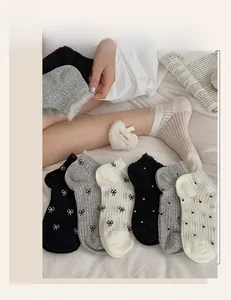 Detailed view of women's lace trim socks featuring black bows and polka dot patterns