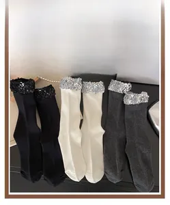 Detail of glitter sequins on black white and grey cotton mid-calf socks for women