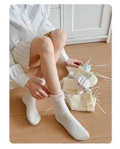 Detail of sweet ballet-style crew socks with ribbon bows and floral checkered cuffs