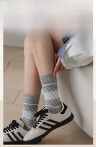 Detail of grey cat pattern mesh socks with elastic ribbed cuffs and breathable cotton fabric