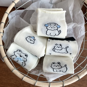 Cute white Westie dog cartoon socks in a woven basket with blue bow accents