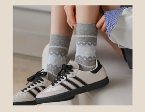 Detailed knit grey mid-calf sock with blue jacquard heart patterns and puppy silhouette