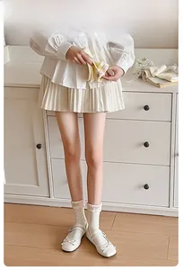 Detail of light beige calf socks with agaric lace trim and soft pink ruffles for women