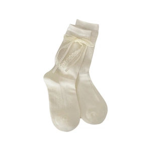 Ballet style cream lace socks with satin ribbons and bows in a flat lay view