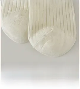 Macro view of detailed ribbed texture and smooth flat toe seam on off-white cotton socks