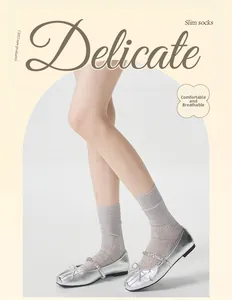 Close-up of light grey lace hollow-out socks with elegant mesh floral pattern details