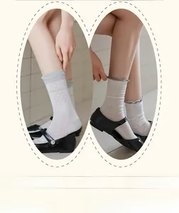Detail of gray mid-calf socks with delicate diamond mesh and wavy stripe textures