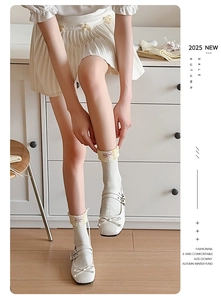 Detail of white cotton socks with floral trim paired with ribbon Mary Jane shoes